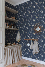 Navy Engla blossom wallpaper by Sandberg in a pantry corner with open shelves and a rattan mirror