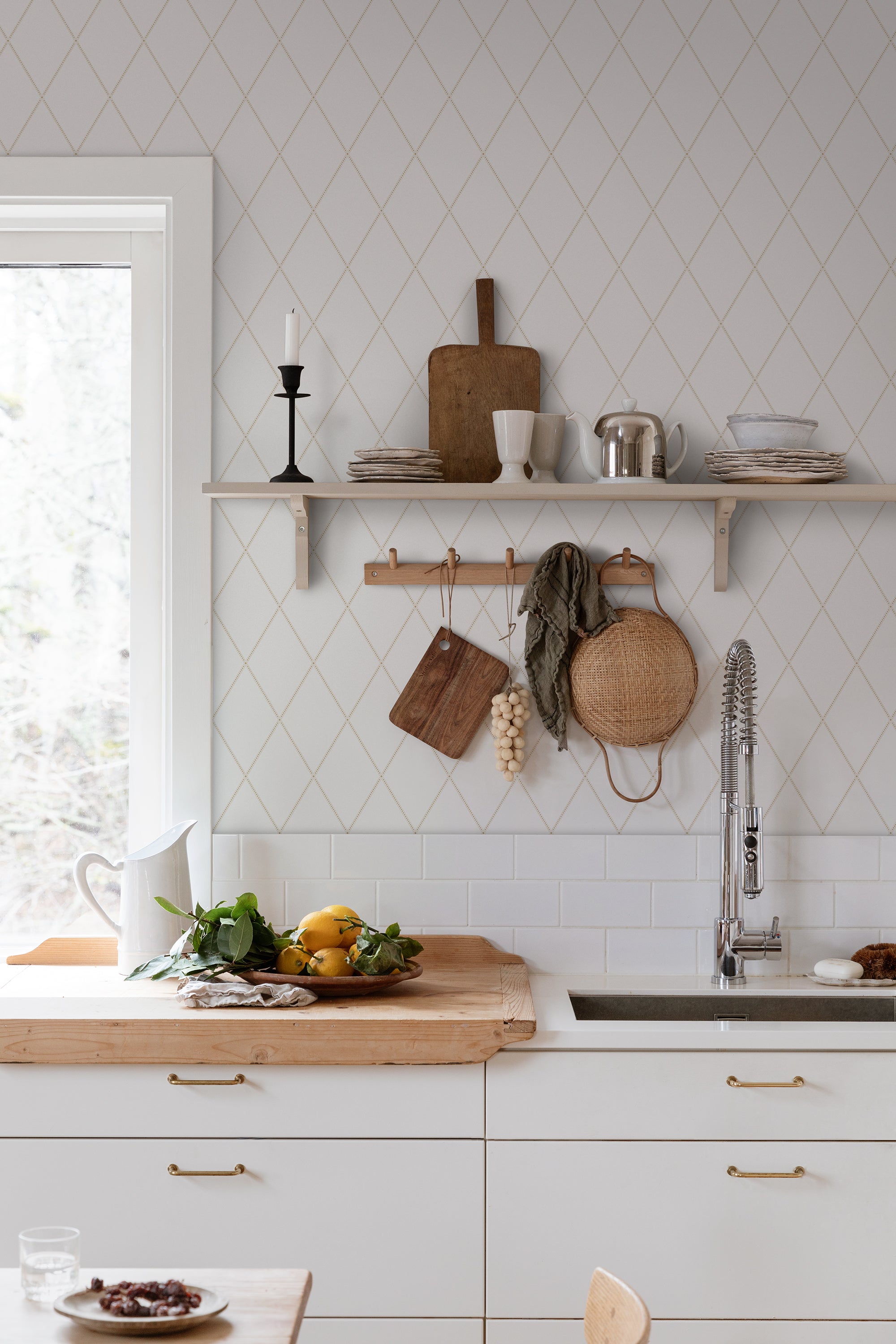 Gabriel wallpaper by Sandberg in white diamond trellis in a kitchen with open shelf, peg rail and timber counter