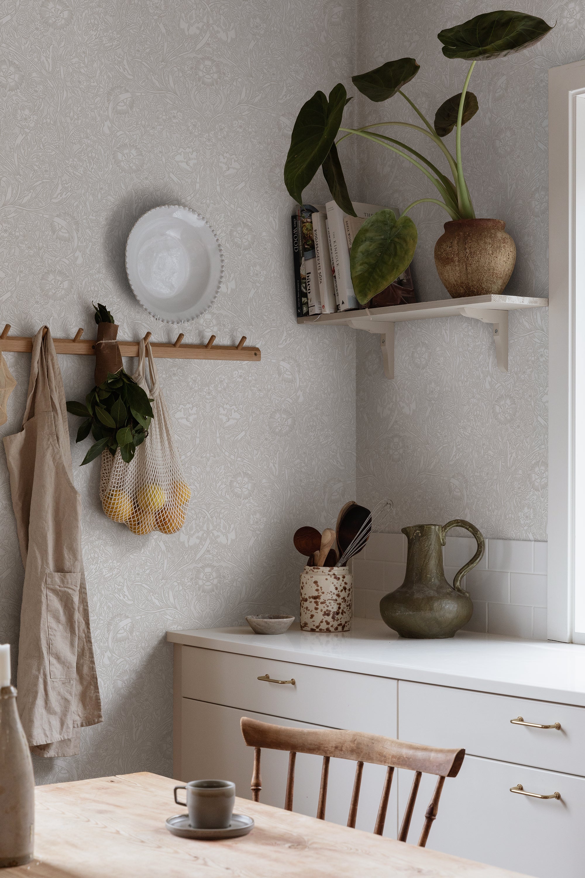 Caroline wallpaper by Sandberg in Sandstone, styled on an interior wall
