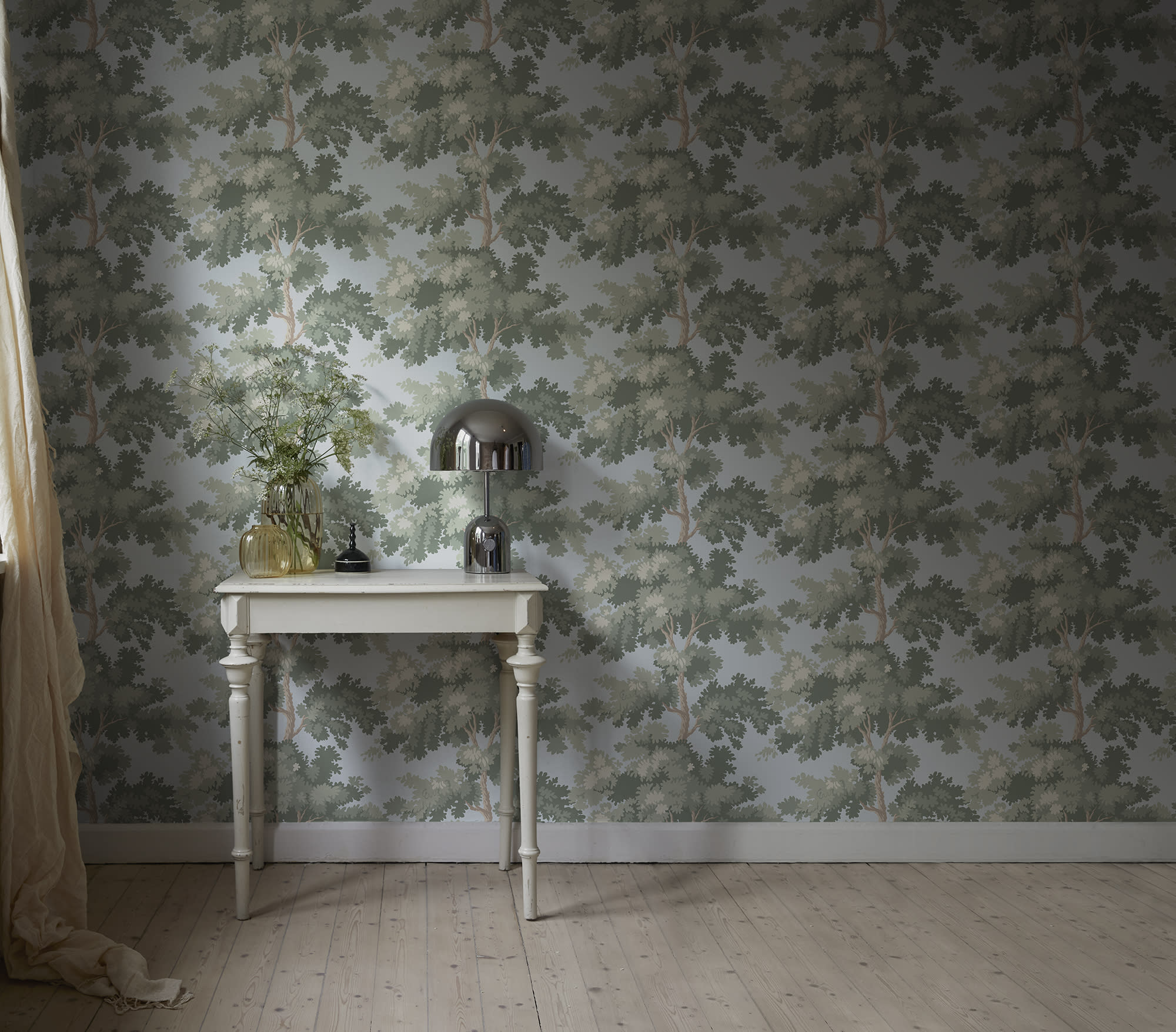 Raphael wallpaper by Sandberg in Green - botanical design, above a small white table