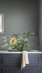 Blue Hugo wallpaper by Sandberg above a marble vanity with grey cabinets and a vase of wildflowers