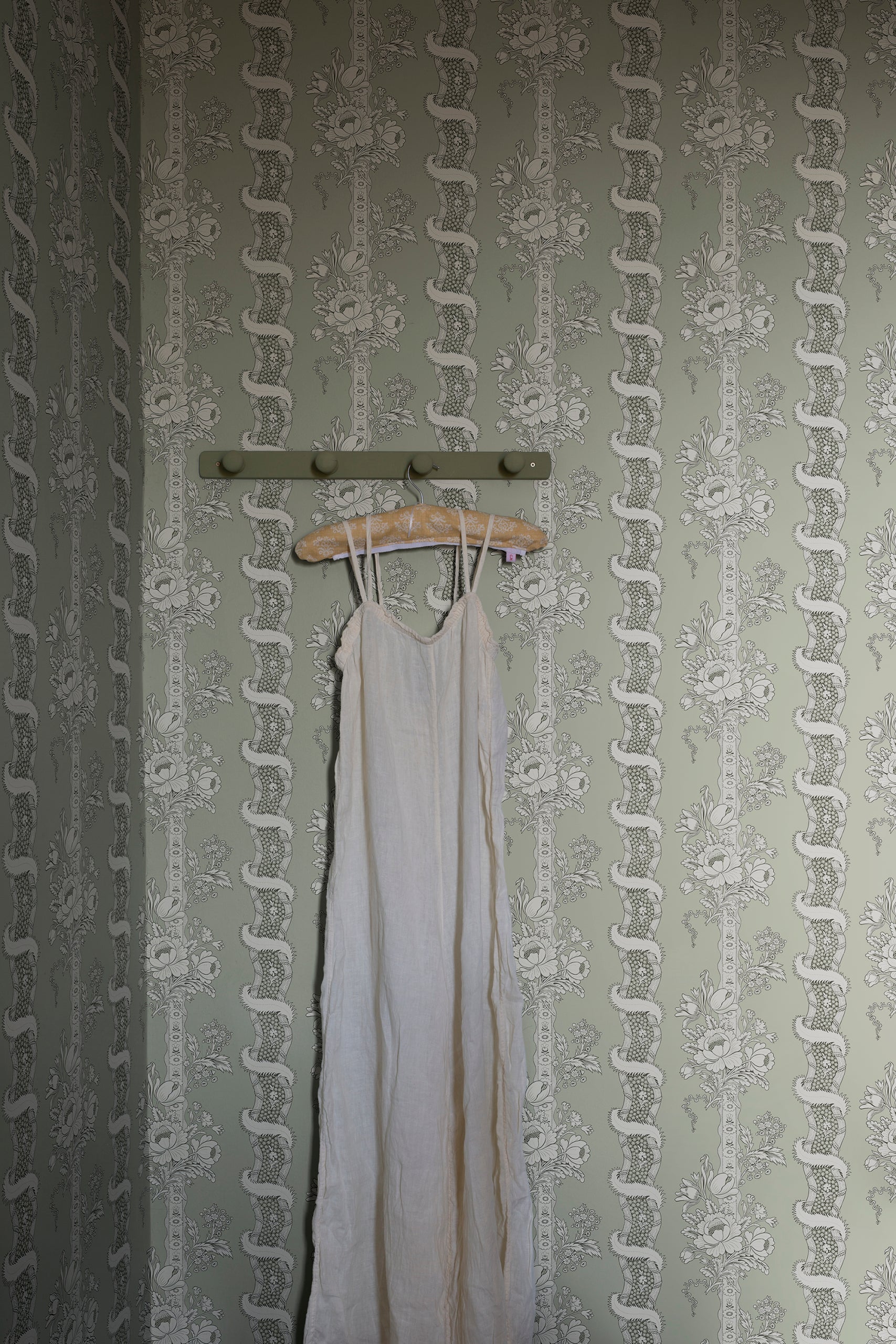 Alexandra wallpaper by Sandberg in Sage Green, styled on an interior wall