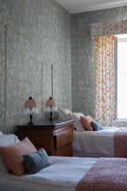 Fig Garden wallpaper by Sandberg in Misty Blue, styled on an interior wall
