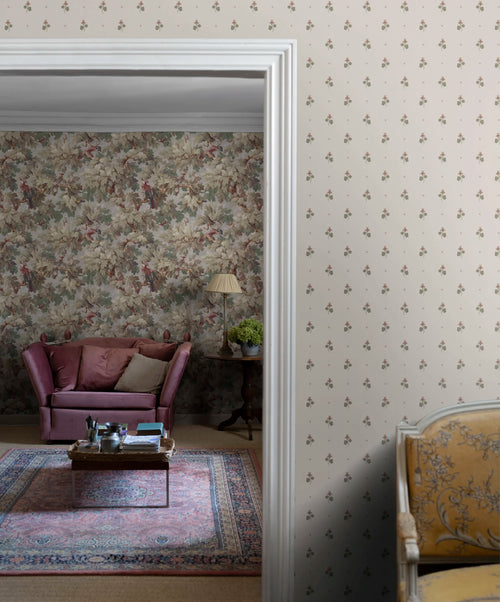 Mimi wallpaper by Sandberg on a hallway wall, small violet-sprig pattern with a vintage living room glimpsed through the