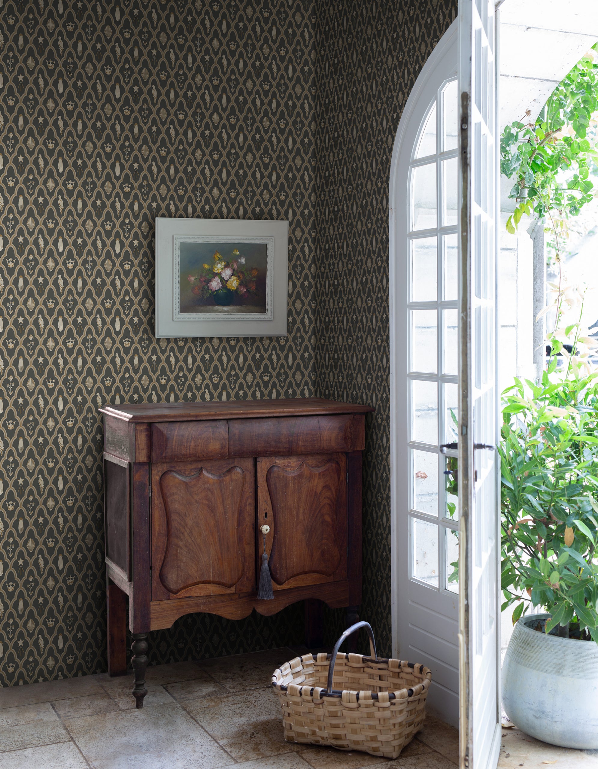 Turtledove Barn wallpaper by Sandberg in dark green styled in an entry with an antique timber cabinet, framed still life and arched door