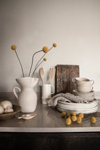 Linne wallpaper by Sandberg in White, styled on an interior wall