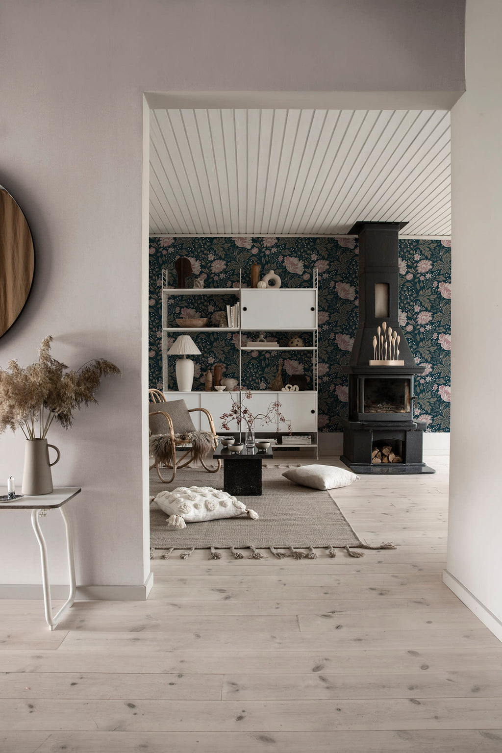 Linne wallpaper by Sandberg in pale tone glimpsed in a Scandinavian living room with a black fireplace