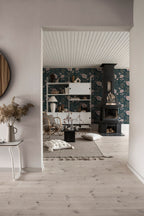 Linne wallpaper by Sandberg in pale tone glimpsed in a Scandinavian living room with a black fireplace