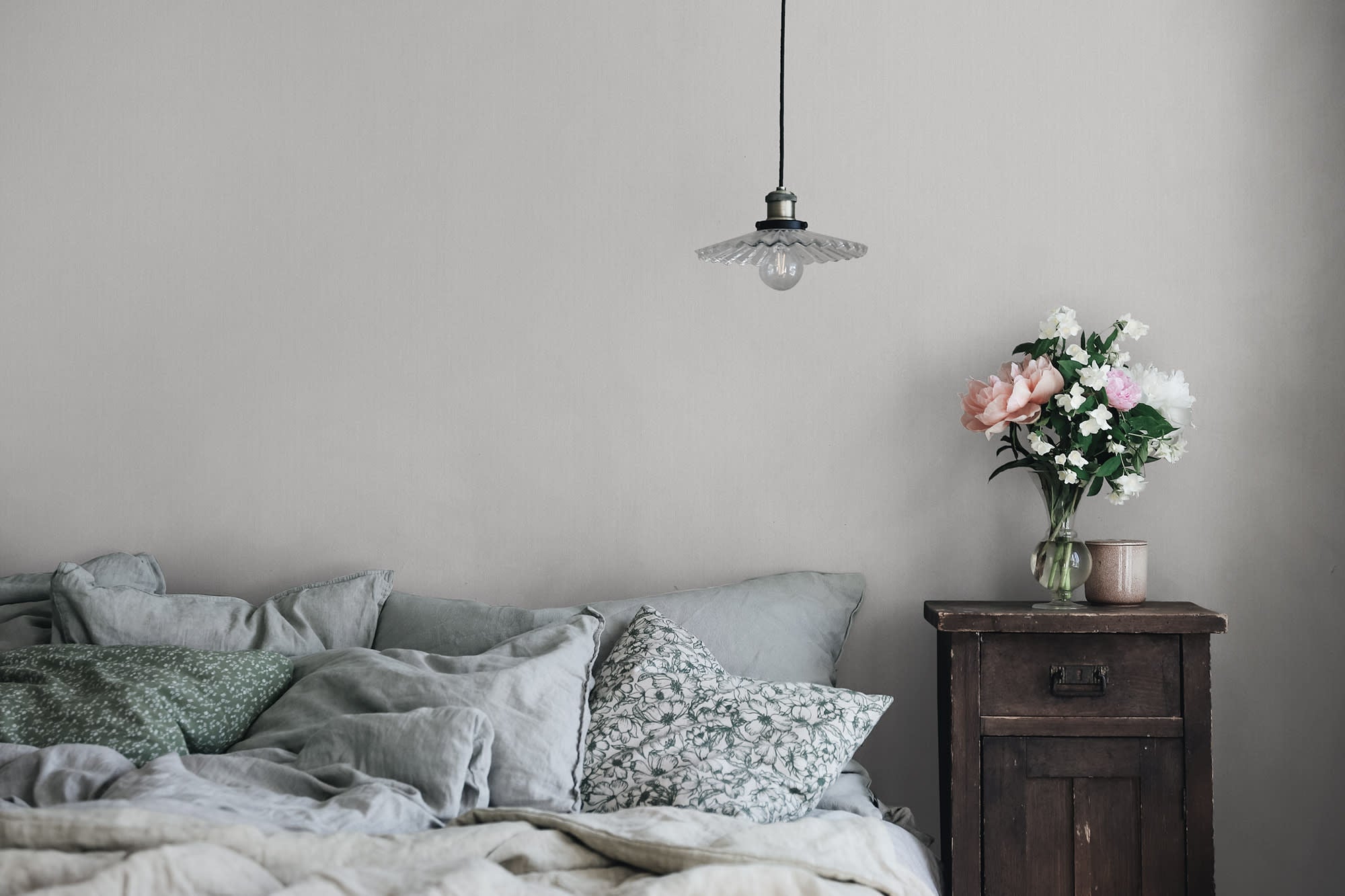Linne wallpaper by Sandberg in Grey, styled on an interior wall