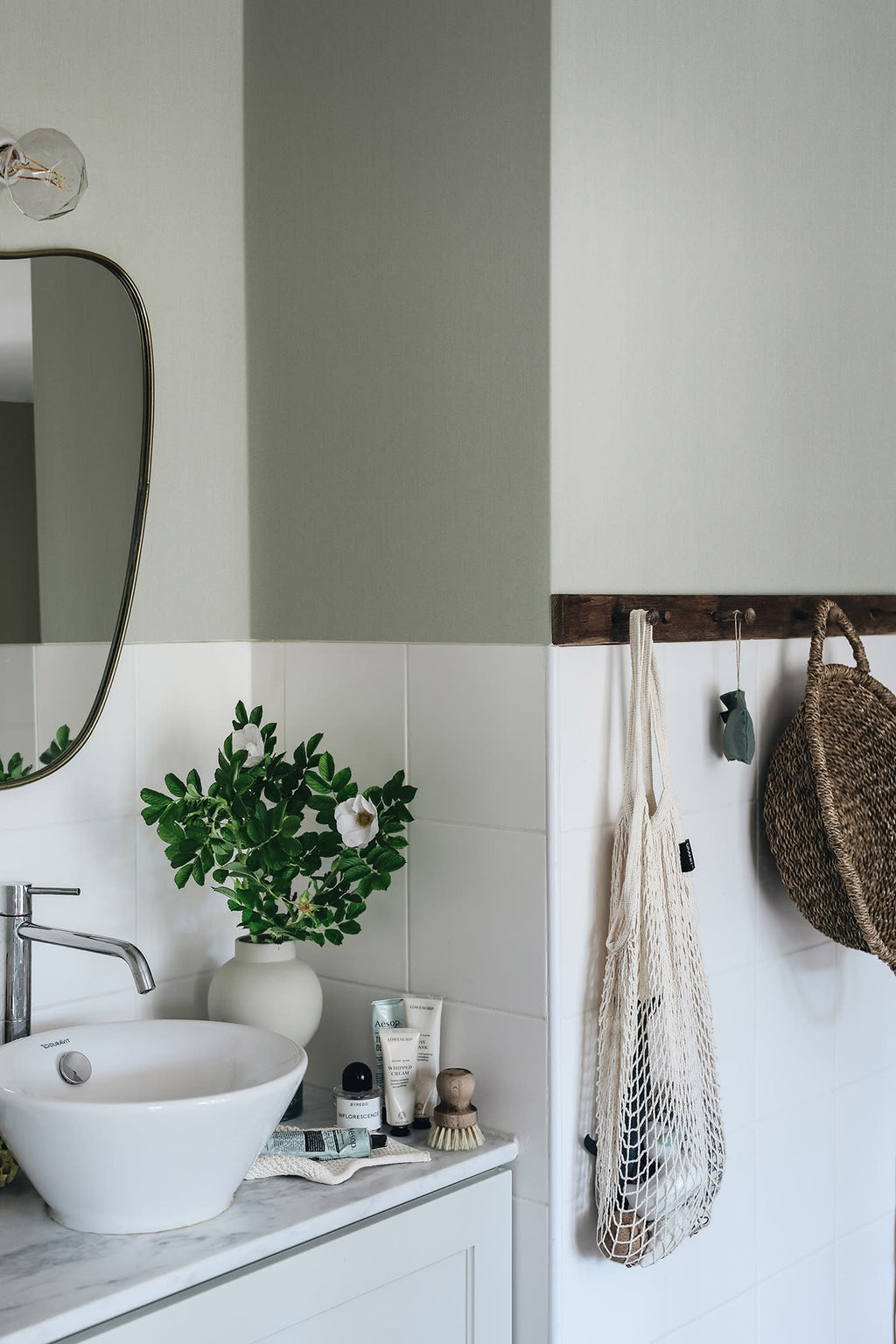 Linne wallpaper by Sandberg in Garden Green, styled on an interior wall