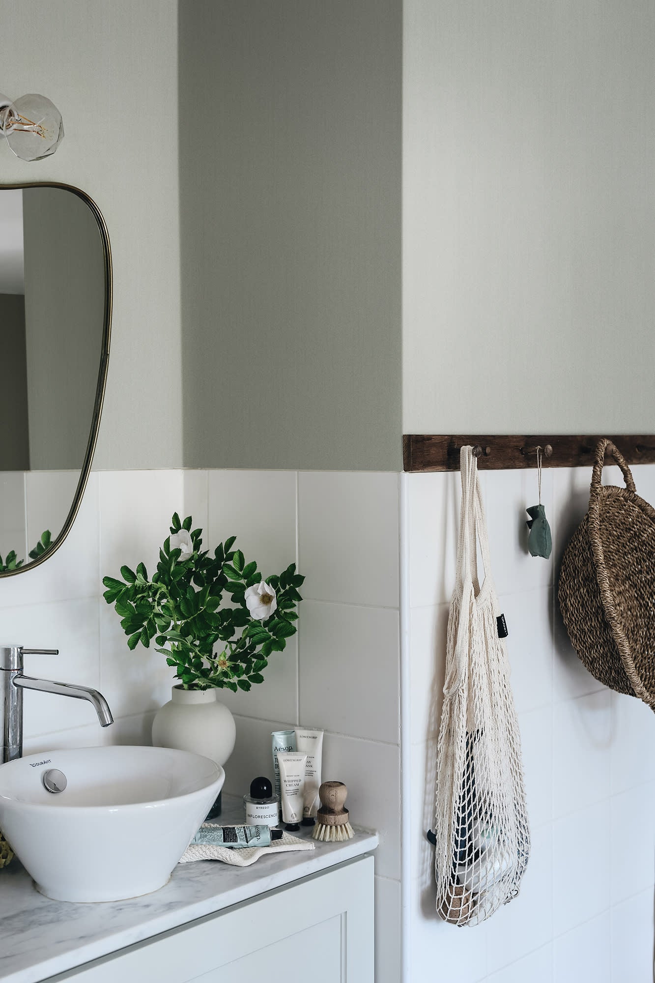 Linne wallpaper by Sandberg in Garden Green, styled on an interior wall