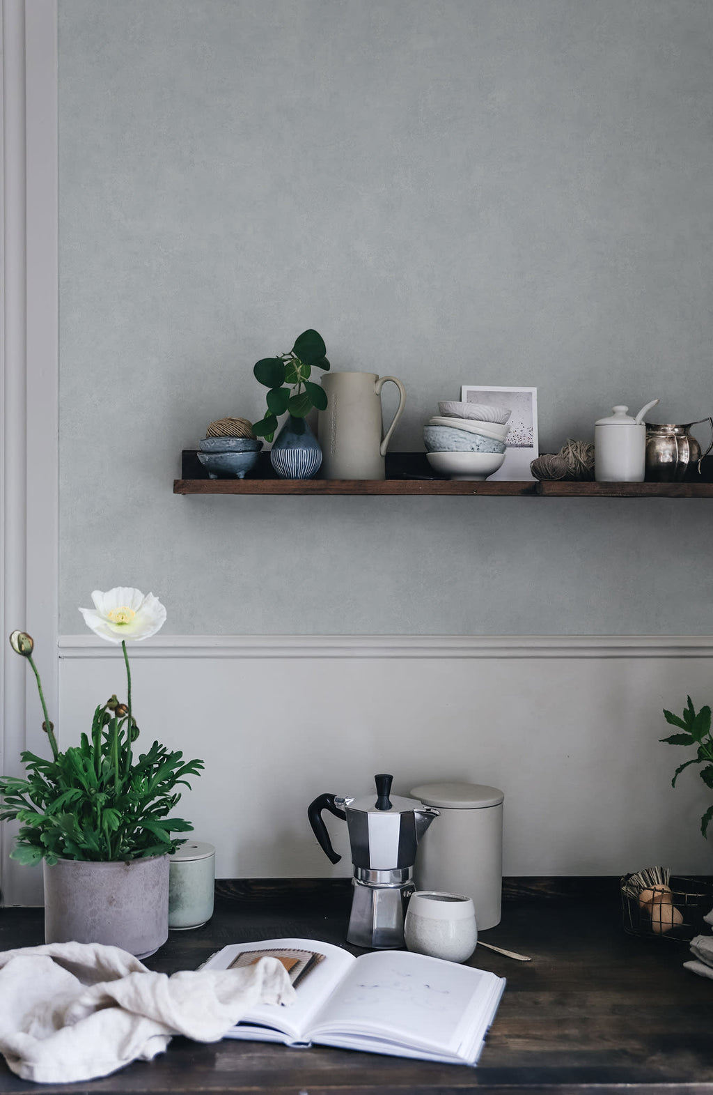 Kalk wallpaper by Sandberg in Misty Blue, styled on an interior wall