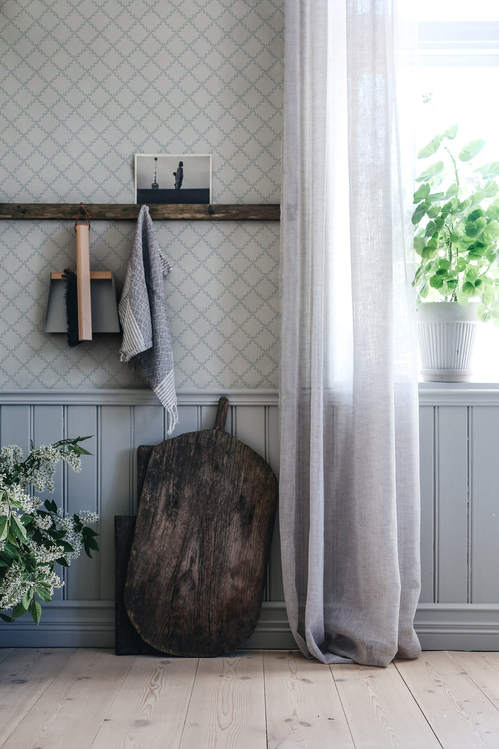 Trellis wallpaper by Sandberg in Misty Blue, styled on an interior wall
