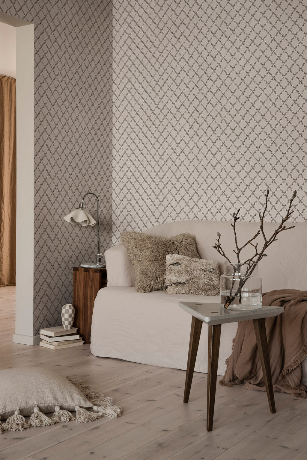 Trellis wallpaper by Sandberg in Graphite, styled on an interior wall