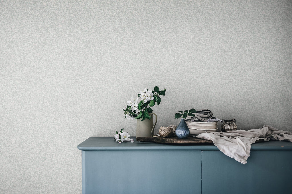 Bladverk wallpaper by Sandberg in Misty Blue, styled on an interior wall
