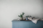 Bladverk wallpaper by Sandberg in Misty Blue, styled on an interior wall
