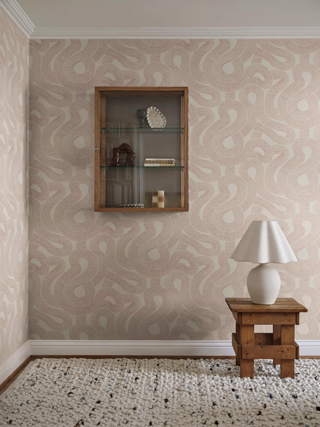 Zen wallpaper by Sandberg in warm beige looping print beside a wall display cabinet and rustic stool with lamp