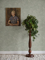 Sage-green Marion marbled wallpaper by Sandberg with a vintage portrait and a topiary on a turned wooden stand