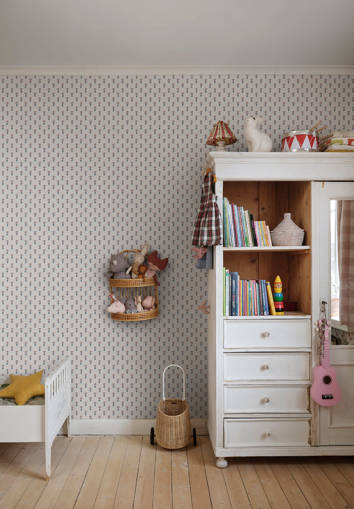 Betty wallpaper by Sandberg in a nursery, tiny blue floral sprig pattern beside a white wardrobe and toddler bed
