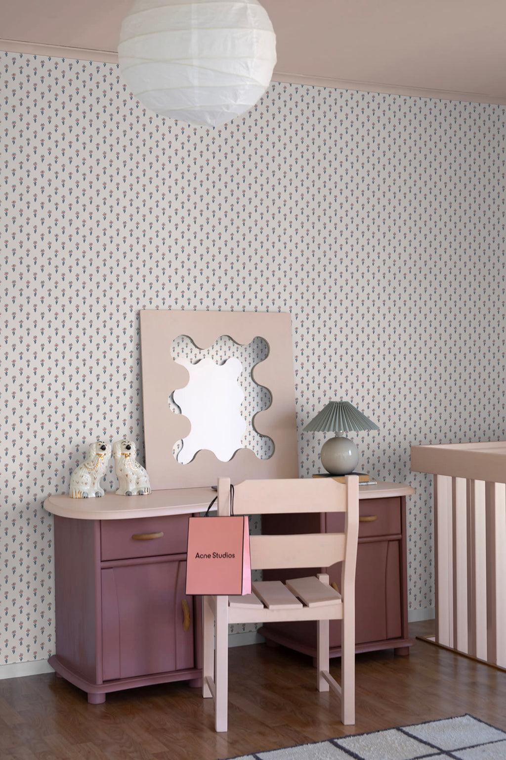 Betty wallpaper by Sandberg in a bedroom corner, small floral sprig pattern behind a mauve desk, wavy mirror and rice-paper pendant