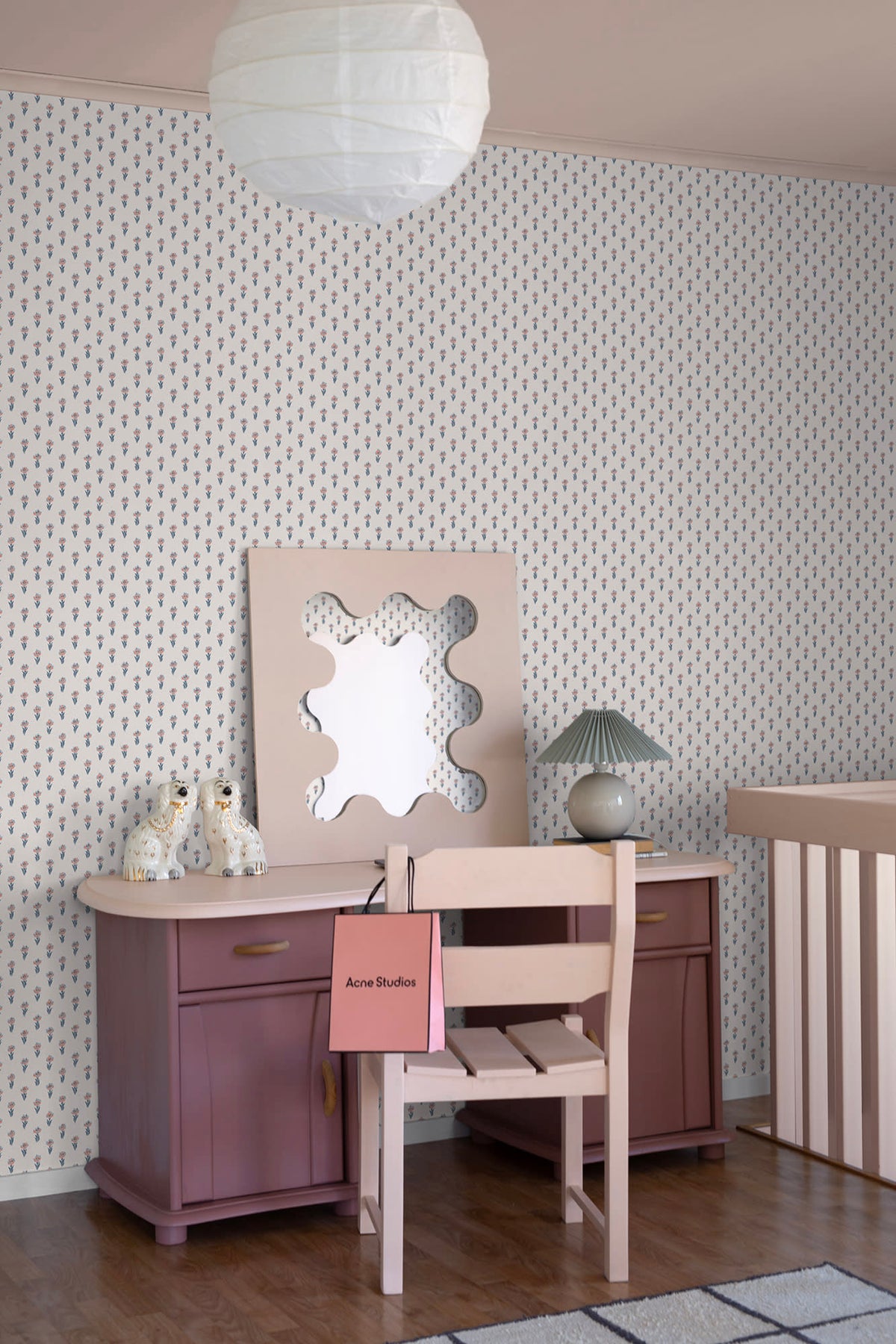 Betty wallpaper by Sandberg in a bedroom corner, small floral sprig pattern behind a mauve desk, wavy mirror and rice-paper pendant