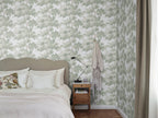 Raphael wallpaper by Sandberg in Green - botanical design, behind a bed with white linen