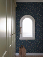 Sanna Sweet Pea wallpaper by Sandberg in navy blue with coral sweet pea blooms around an arched window