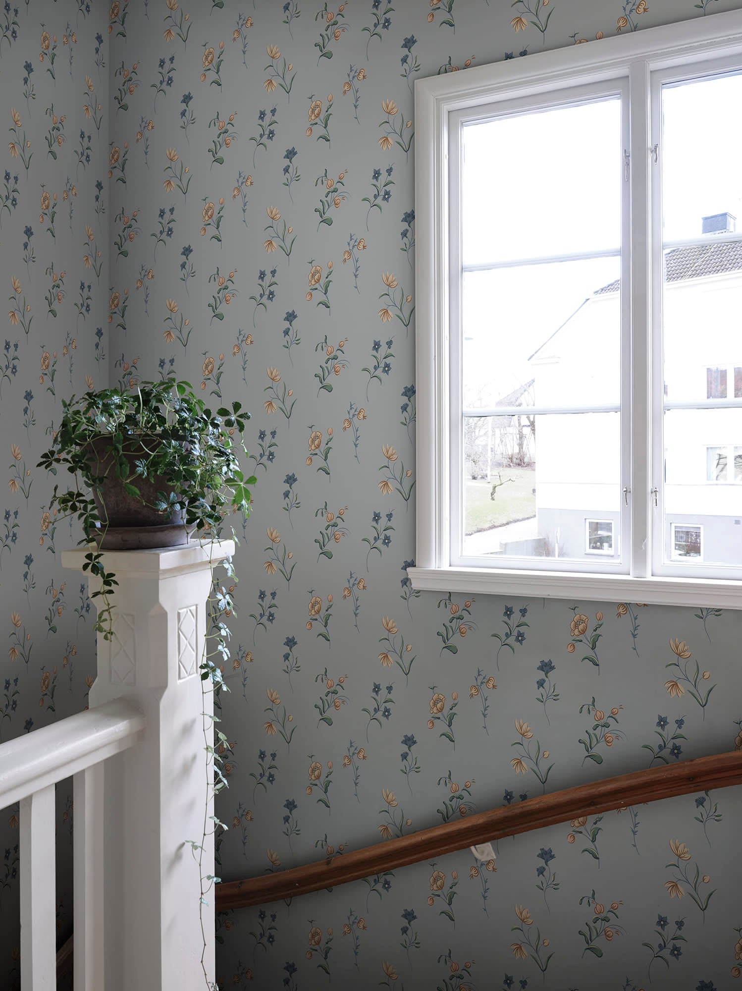 Hanna wallpaper by Sandberg in Misty Blue, styled on an interior wall