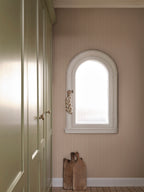 Linn wallpaper by Sandberg in Pink, styled on an interior wall
