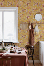 Rosenholm wallpaper by Sandberg – floral design, Yellow, styled on an interior wall