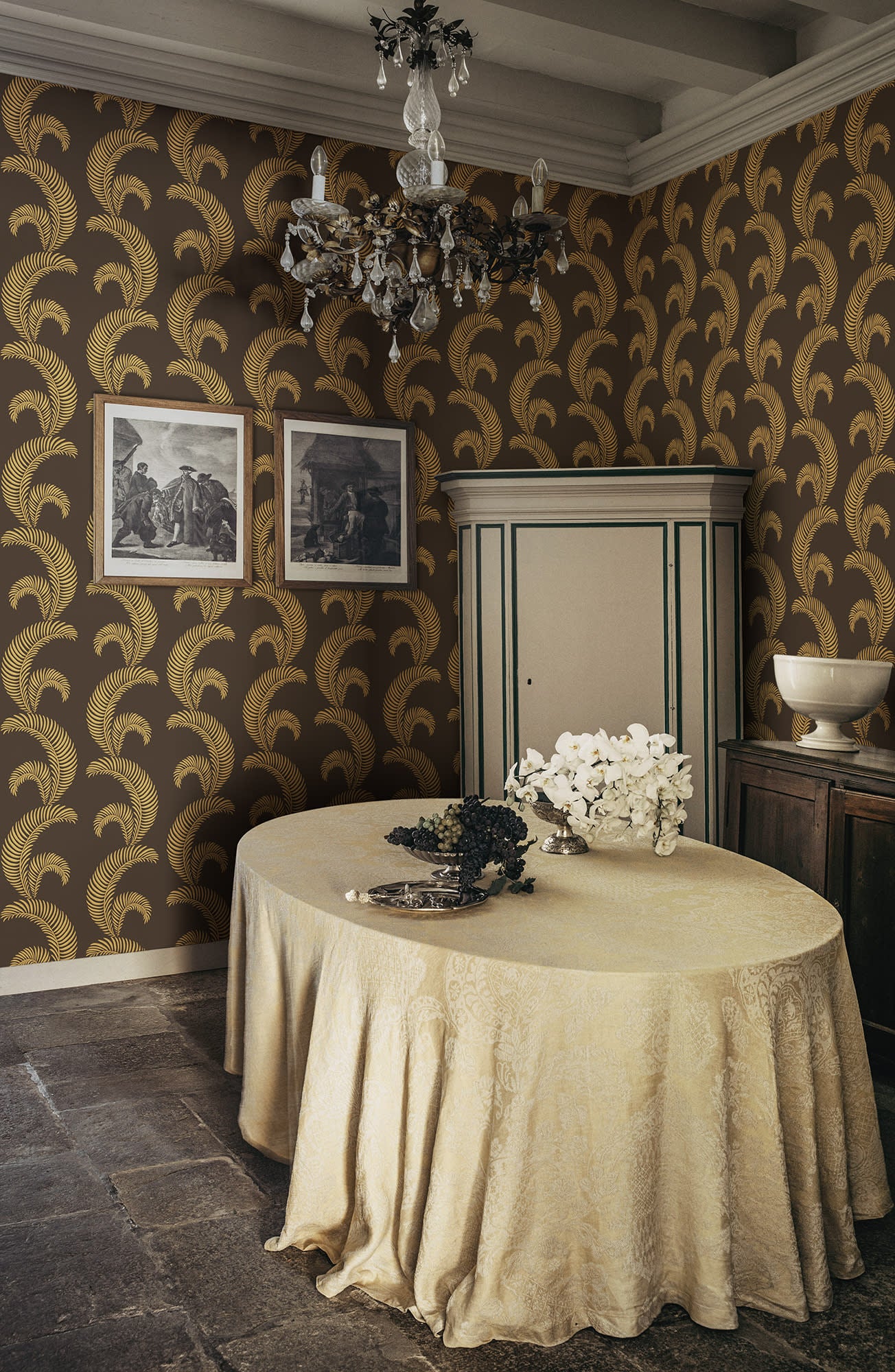 Jasmine wallpaper by Sandberg in gold on brown in a dining room with a draped table and crystal chandelier