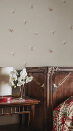 Butterflies wallpaper by Sandberg in Sandstone shown on a wall in a styled room