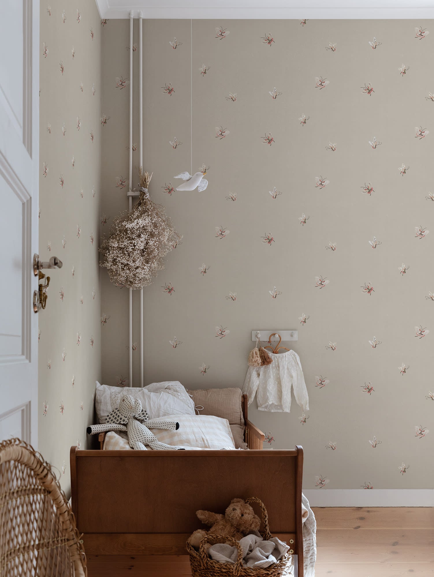 Butterflies wallpaper by Sandberg in Sandstone shown on a wall in a styled room