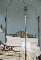 Butterflies wallpaper by Sandberg in Misty Blue shown on a wall in a styled room