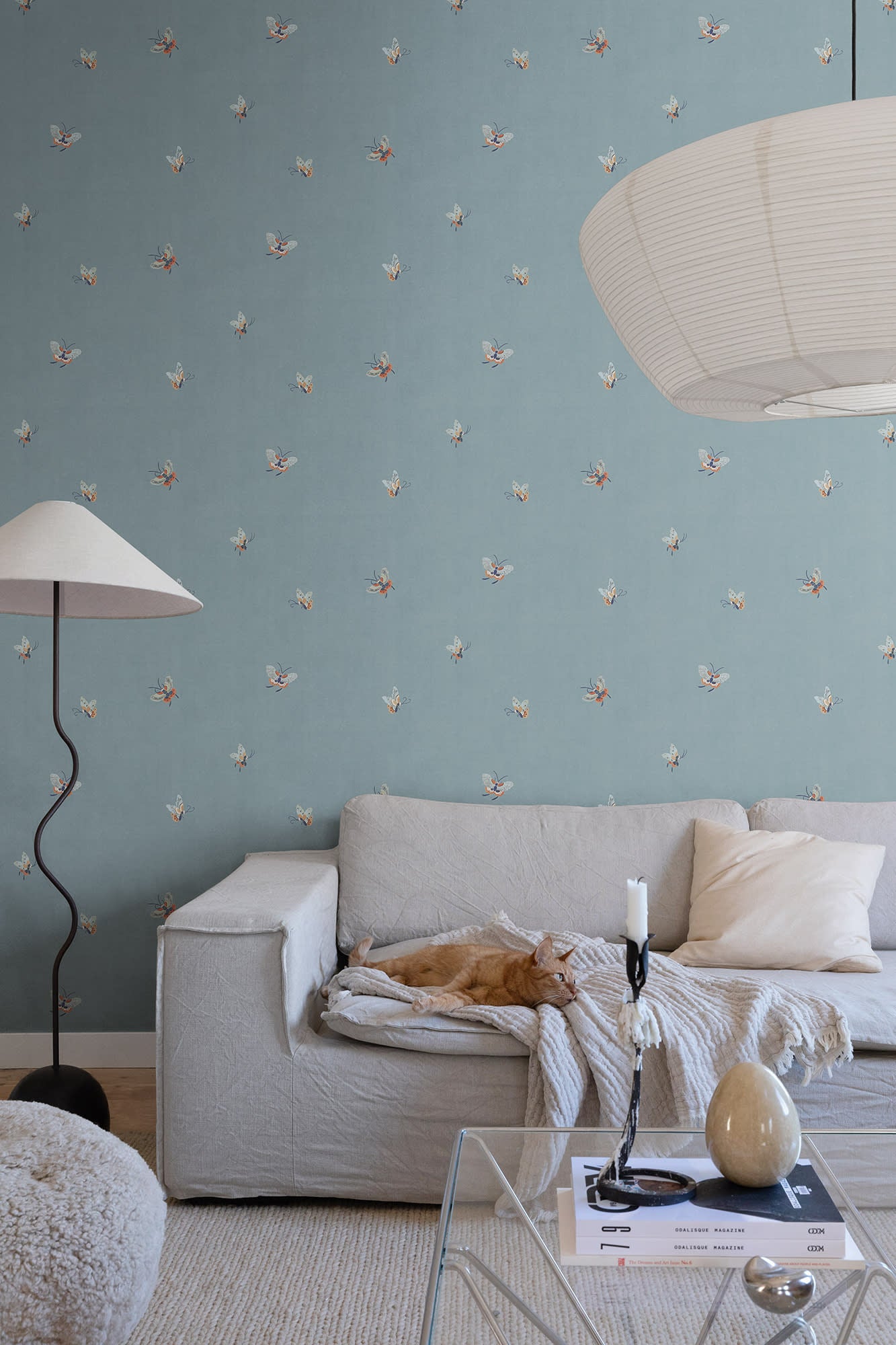 Butterflies wallpaper by Sandberg in Misty Blue shown on a wall in a styled room