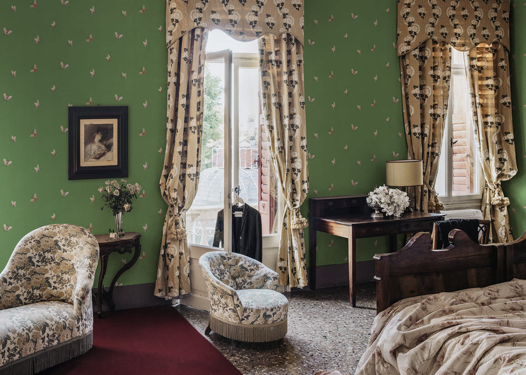 Butterflies wallpaper by Sandberg in Green shown on a wall in a styled room