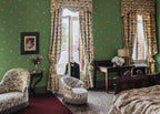 Butterflies wallpaper by Sandberg in Green shown on a wall in a styled room
