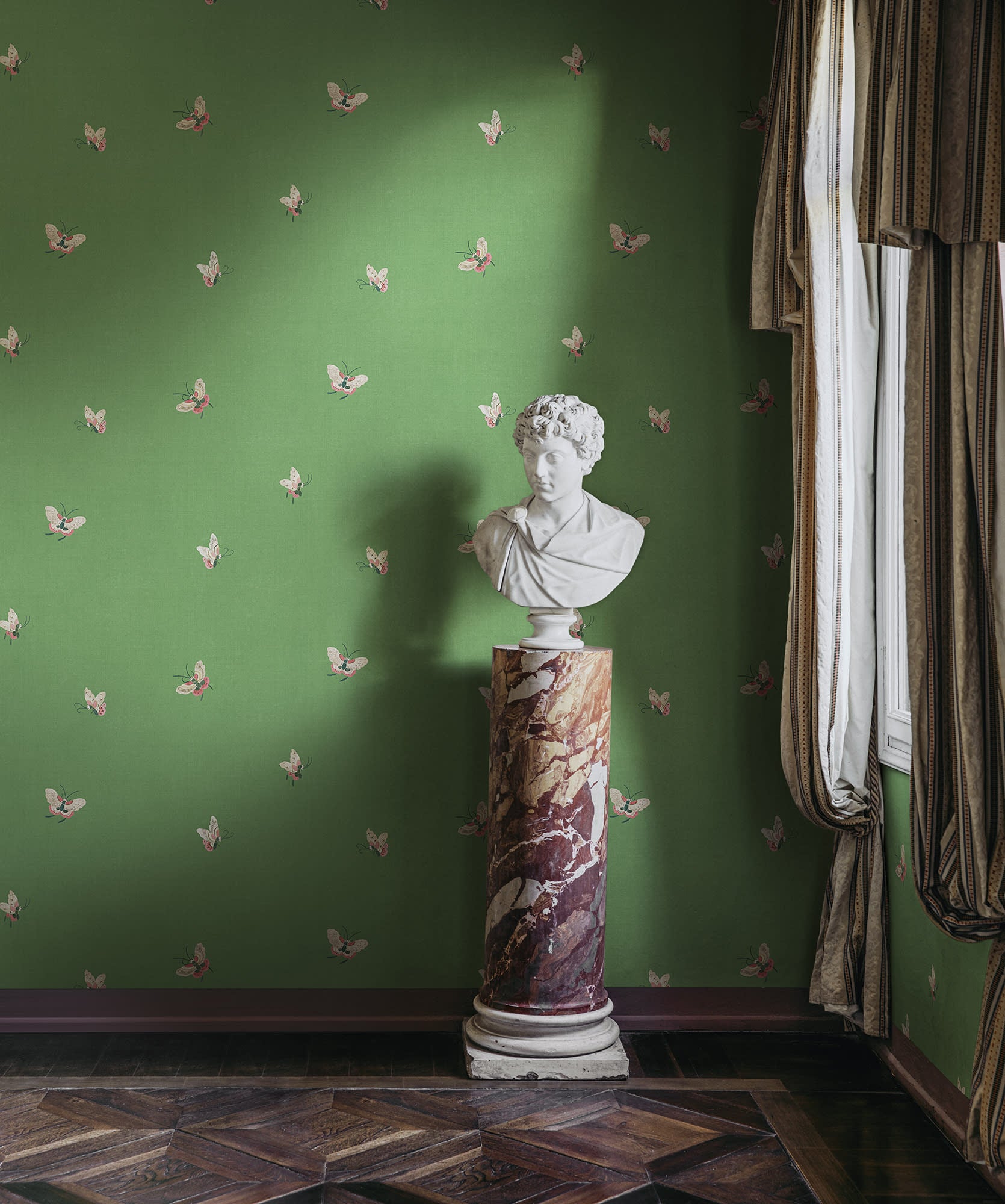 Butterflies wallpaper by Sandberg in Green shown on a wall in a styled room