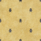 Audrey wallpaper by Sandberg, charcoal scarab beetle motif on a warm mustard-yellow ground, flat swatch