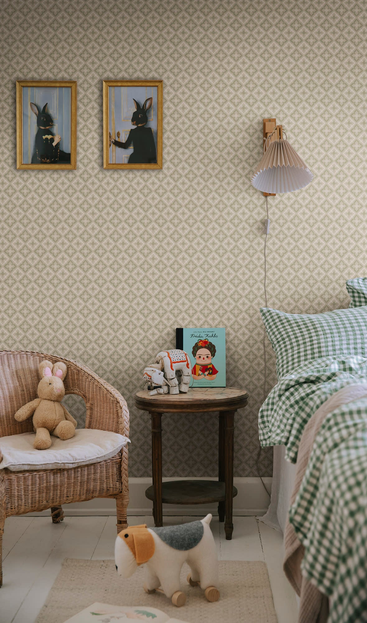 Edvin wallpaper by Sandberg in sage green in a child bedroom with rabbit art and gingham bedding