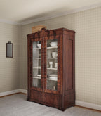 Edvin wallpaper by Sandberg in sage green in a dining room behind an antique mahogany china cabinet