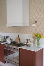 Ewa wallpaper by Sandberg in warm sand with pink trellis florals in a kitchen with terracotta cabinets