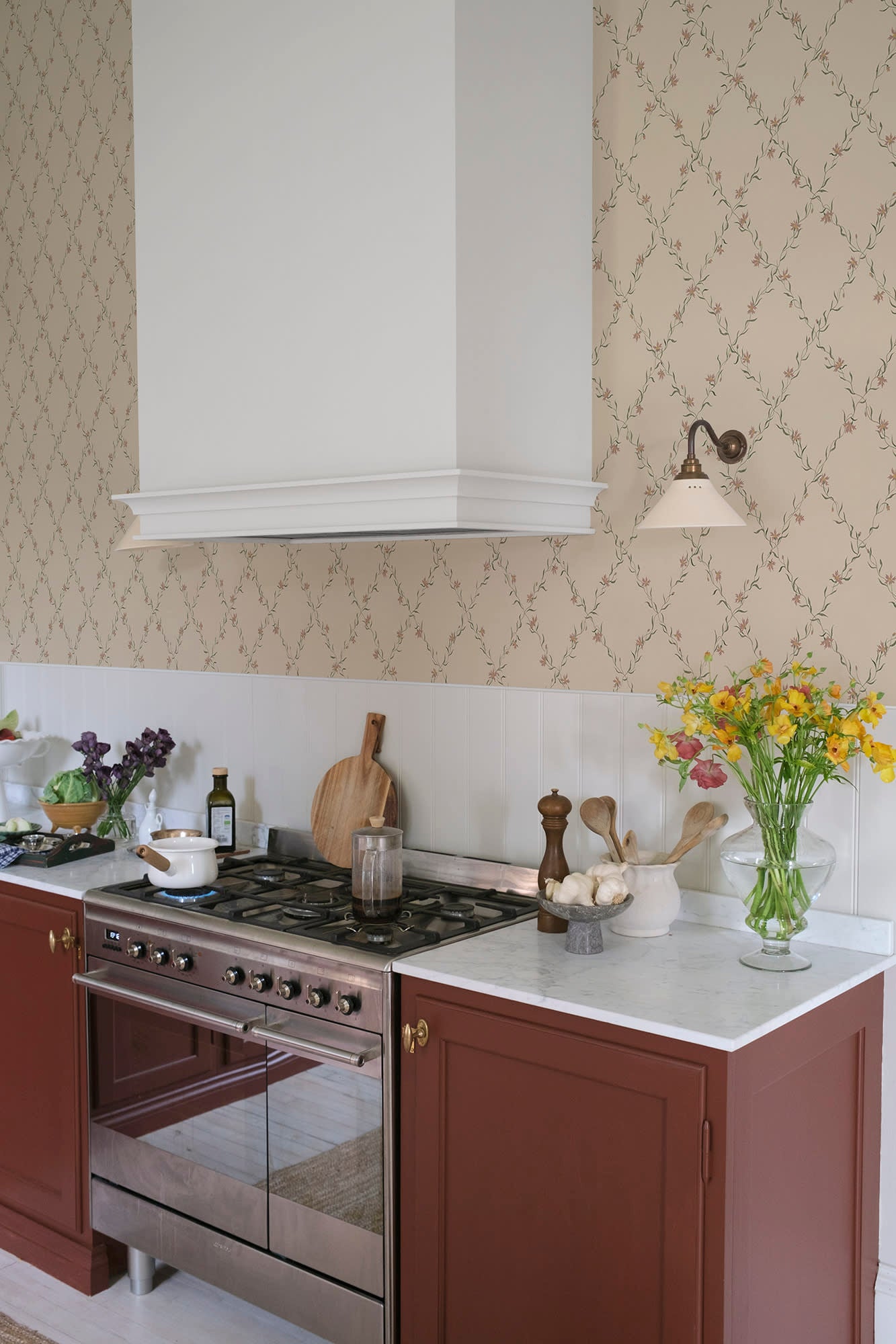 Ewa wallpaper by Sandberg in warm sand with pink trellis florals in a kitchen with terracotta cabinets