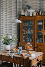 Erik wallpaper by Sandberg in Indigo Blue, styled on an interior wall
