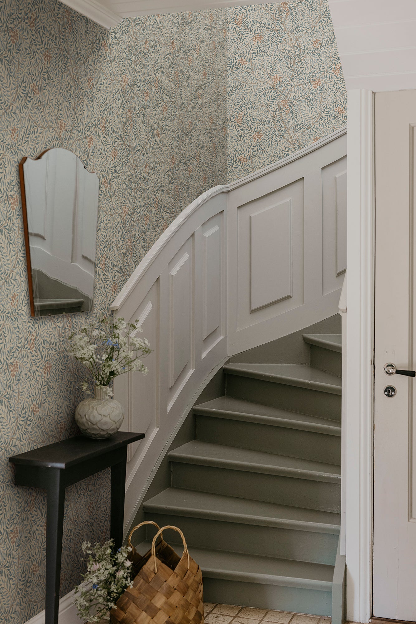 Simon wallpaper by Sandberg in Misty Blue, styled on an interior wall