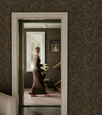 Simon wallpaper by Sandberg in dark green in a hallway framing a woman in a doorway by a window