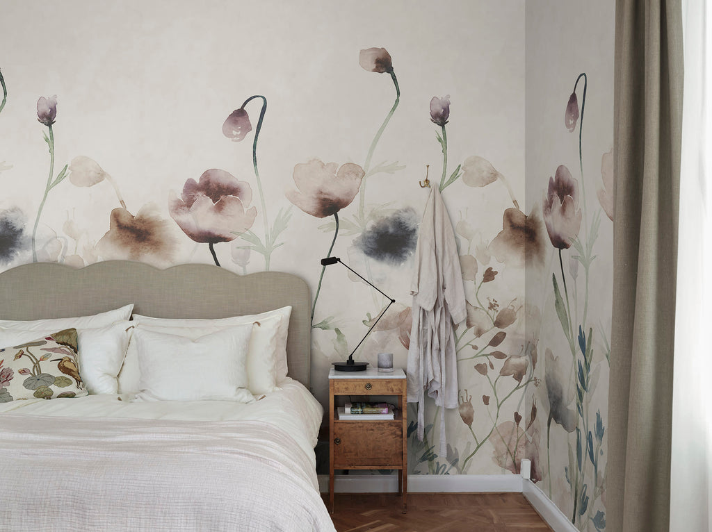Morängen Floral wall mural by Sandberg in soft pink, watercolour poppies and meadow flowers behind an upholstered bed