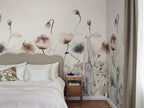 Morängen Floral wall mural by Sandberg in soft pink, watercolour poppies and meadow flowers behind an upholstered bed
