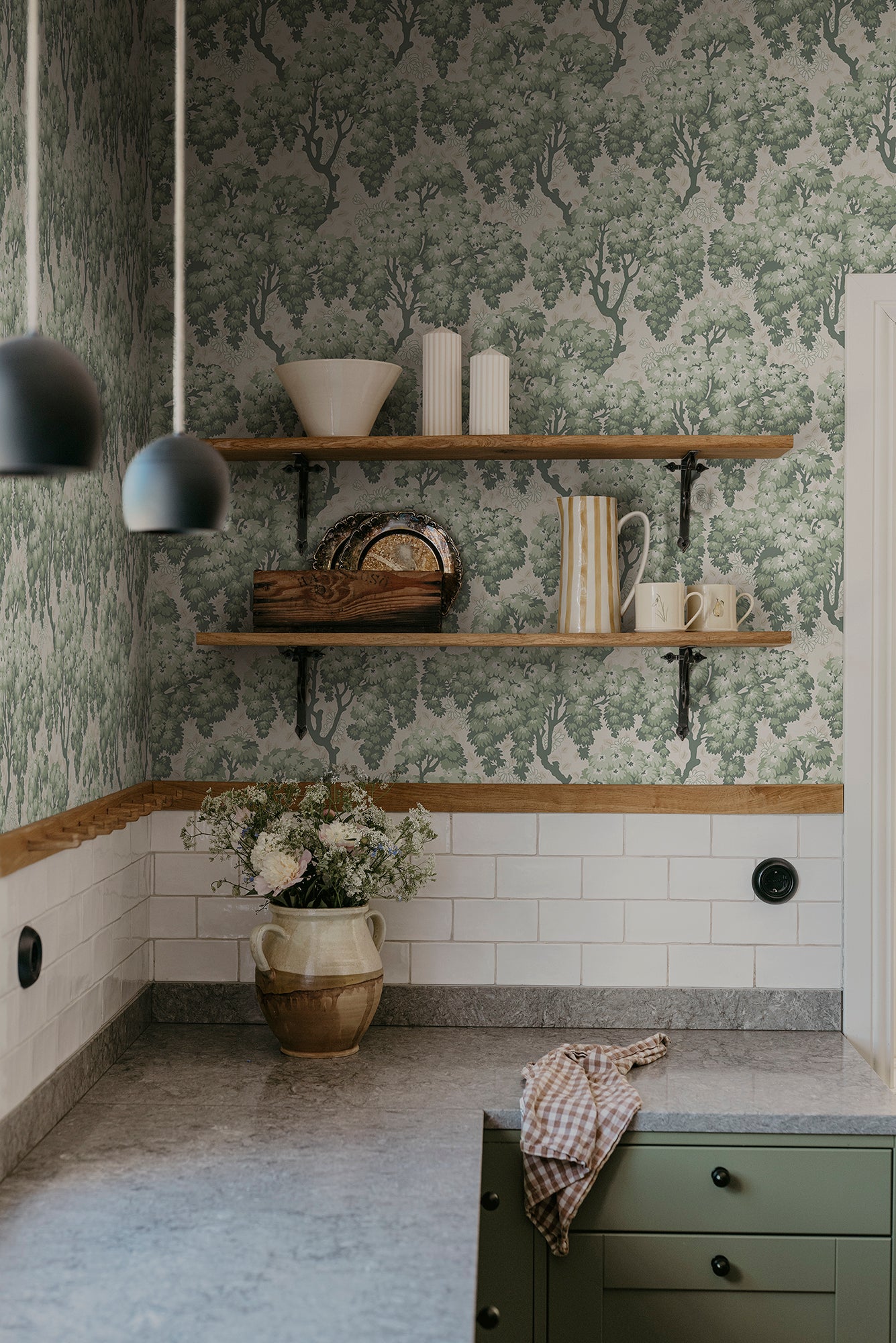 Ragnvi wallpaper by Sandberg in Green, styled on an interior wall