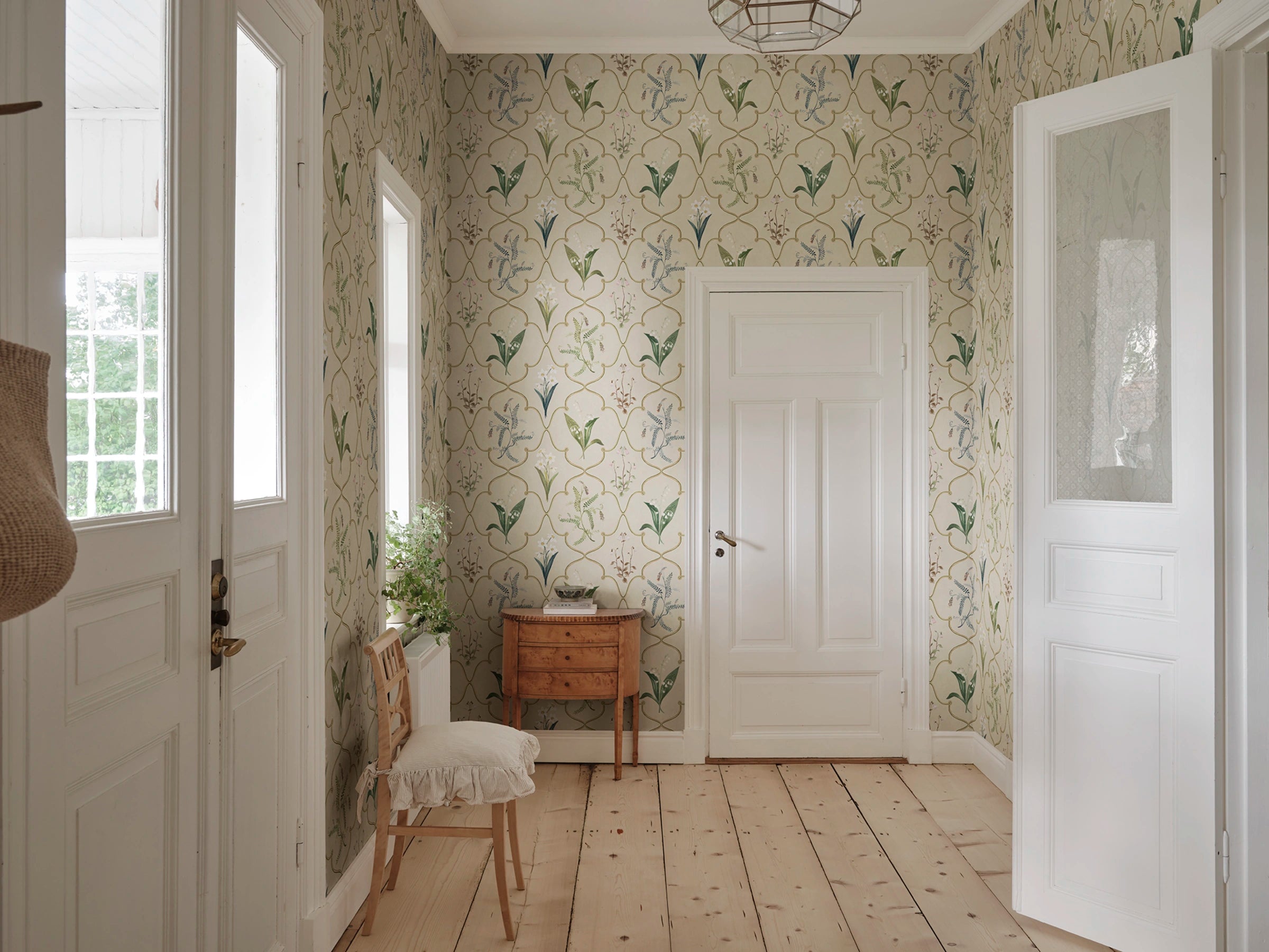 Louise wallpaper by Sandberg – botanical design, Clay, styled on an interior wall